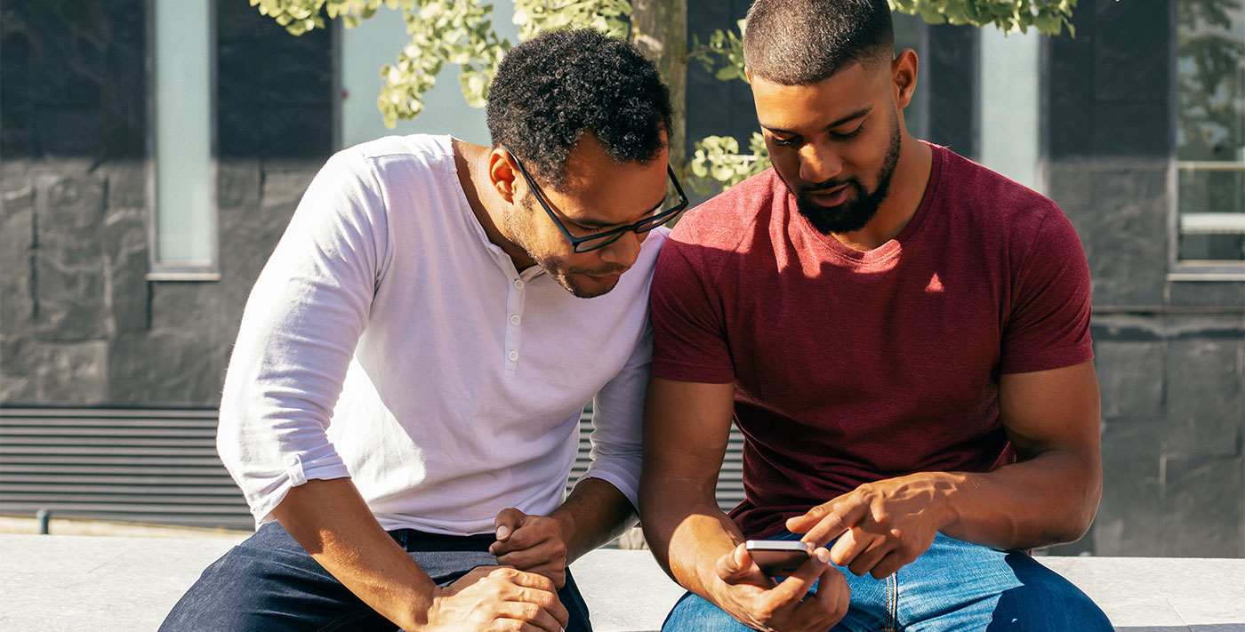 two males looking at a cell phone