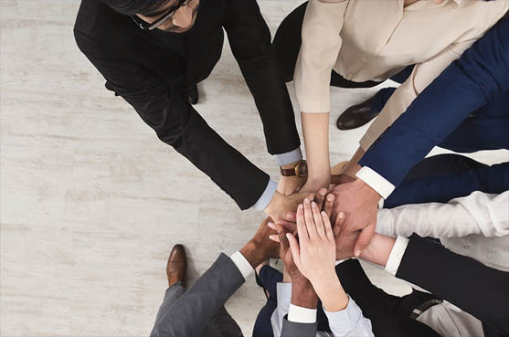 a group of professionals with their hands stacked on top of one another