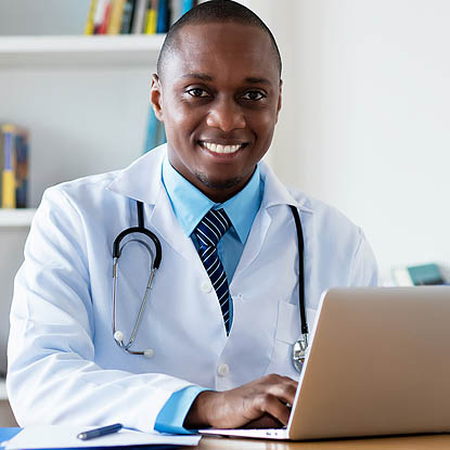 a doctor at his computer watching a webinar