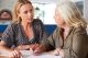 a woman with her mother discussing important documents