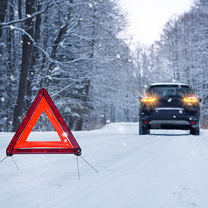 a car on the side of the road in winter weather