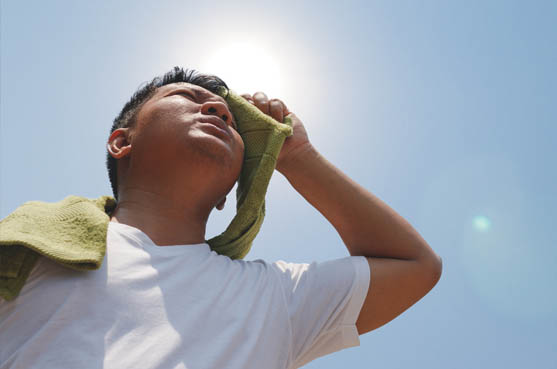 a man wiping sweat from his brow